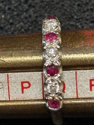 An 18ct gold ruby and diamond ring having seven stones alternating in colour 3.46 gm