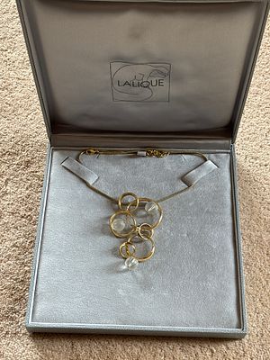 A Lalique Halo gold plated pendant with chain in original box