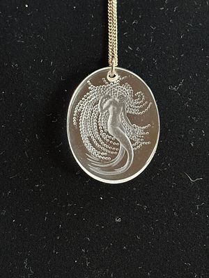 A Lalique Crystal Naiade Mermaid pendant and chain in original pouch. Please note that the 