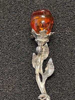 A White metal stylised brooch in the shape of a flower