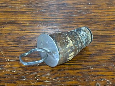 A white metal bottle stopper