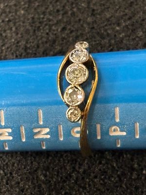 An 18ct platinum, five stone diamond ring size O weighing 2.7 gm