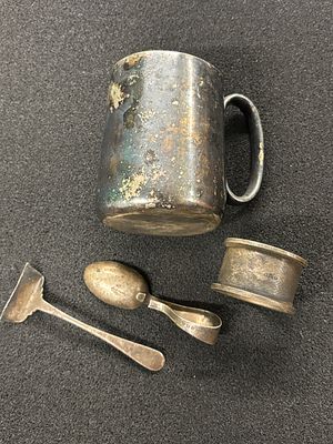 A christening set from 1943 comprising Hallmarked napkins ring, pusher and spoon (a/f) weighing 