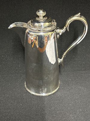 A silver plated hot water jug by Walker &amp; Hall presented as a wedding present to Miss 
