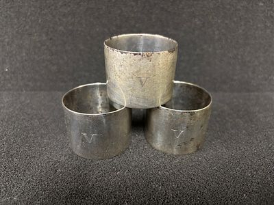 Three HM Silver napkin rings engraved with the letter V weighing 143.80 gm