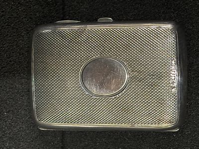 A white metal purse with blue lining measuring 8cm x 5 cm