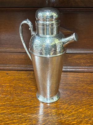 A silver plated planished cocktail jug being 30 cm tall