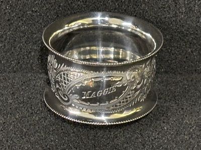 A HM silver napkin ring inscribed "Maggie" weighing 21.89 gm