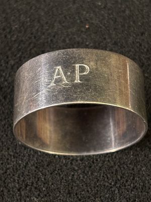 A HM Silver napkin ring with initials "A P" weighing 26.94 gm
