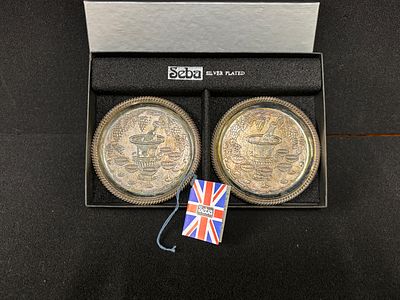 A pair of silver plated SEBA coasters in original box