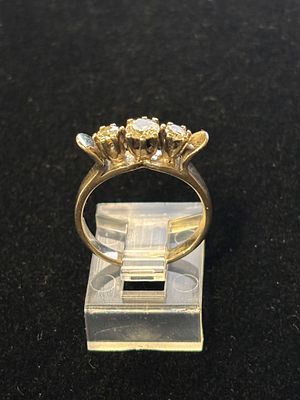A white metal and diamond ring having three stones size L