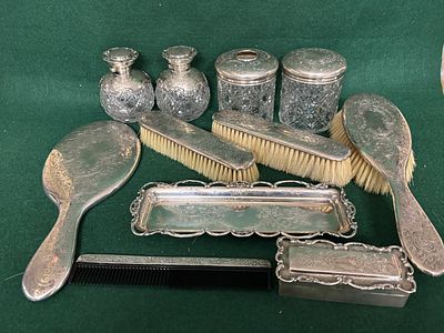 An eleven piece HM silver dressing table set comprising two scent bottles, two lidded jars 