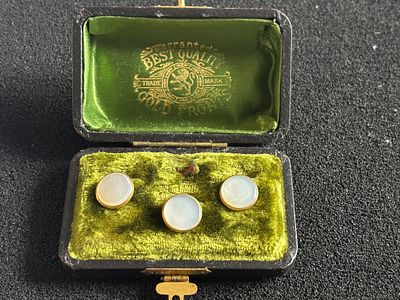 Three Mother of Pearl dress studs with floral decoration on the stems, not yet tested