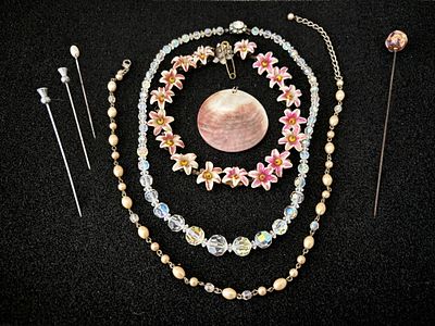 An Aurora Borealis and delicate flower necklace together with an engraved shell and bead 