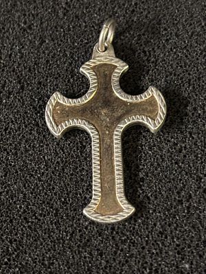 A HM Silver crucifix with coloured inlay which measures 4cm x 3 cm and weighing 8.09gm