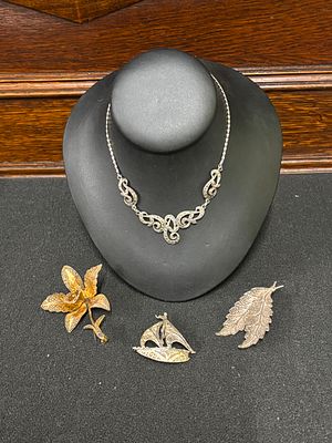 A marcasite necklace together with three filigree brooches