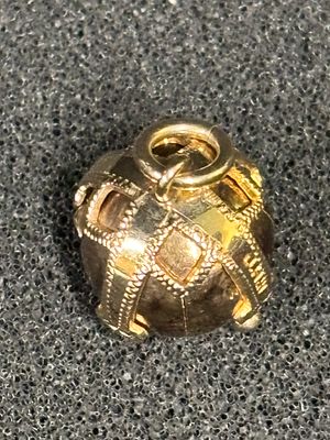 A gold Masonic Ball (999) by JHW England weighing 8.23 gm