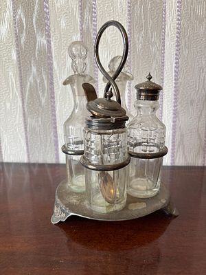 A silver plated cruet set on stand