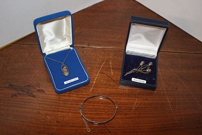 A Trio of Vintage Silver Jewellery comprising a Pendant Necklace, a Floral Brooch, and a Hinged 