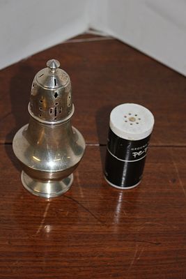Two Tabletop Items comprising a Footed Sugar Caster and a Pepper Shaker. This lot includes two 