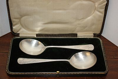 A Pair of Cased Silver Serving Spoons with Bright-Cut Engraved Decoration. A pair of cased 