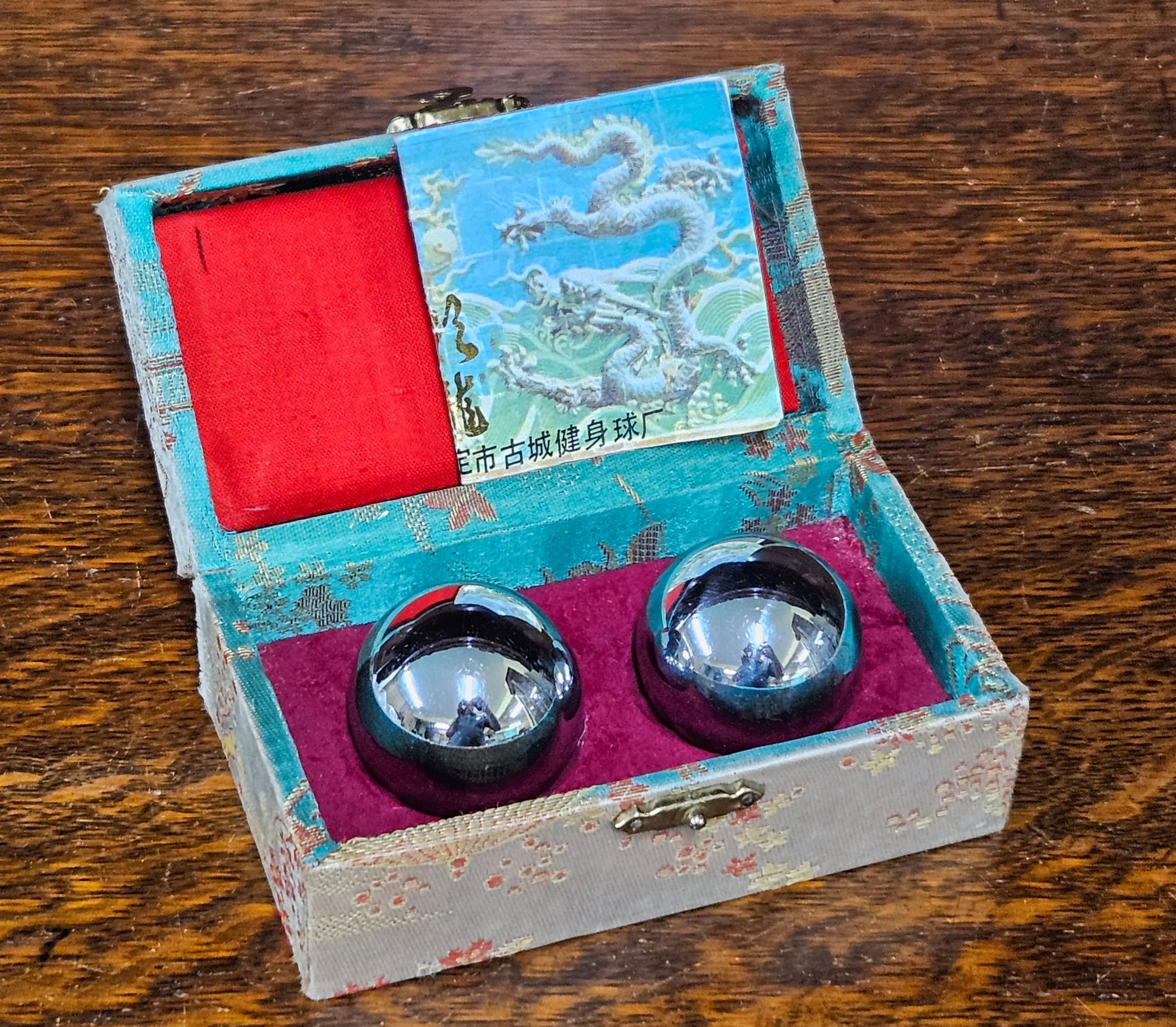 A Pair of Chrome-Plated Metal Baoding Meditation Balls in a Brocade Presentation Box