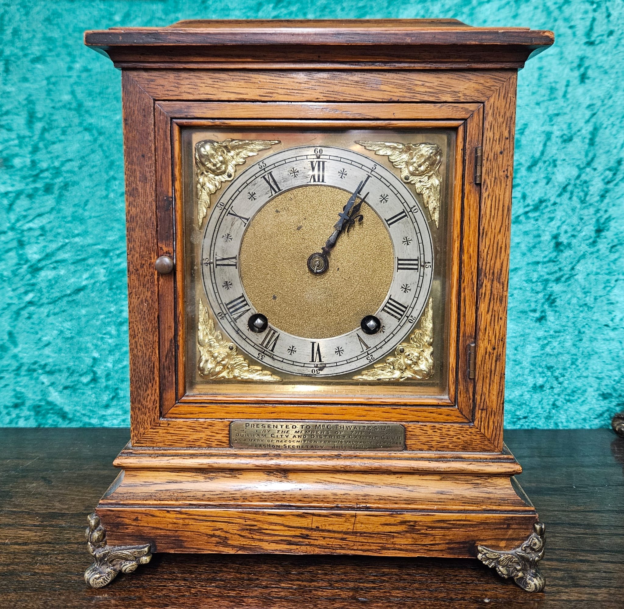 A Victorian Oak Cased Bracket Clock with Brass Mounts and Presentation Plaque Dated 1892
