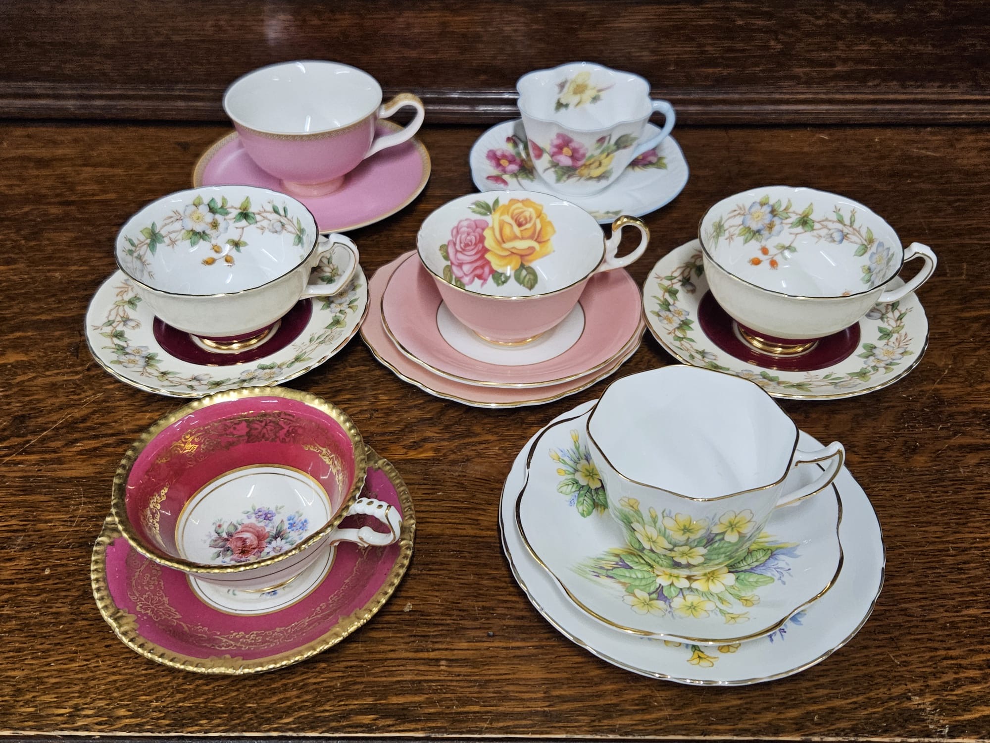 A Collection of Seven Floral and Gilt Decorated Fine China Teacup Sets and Trios