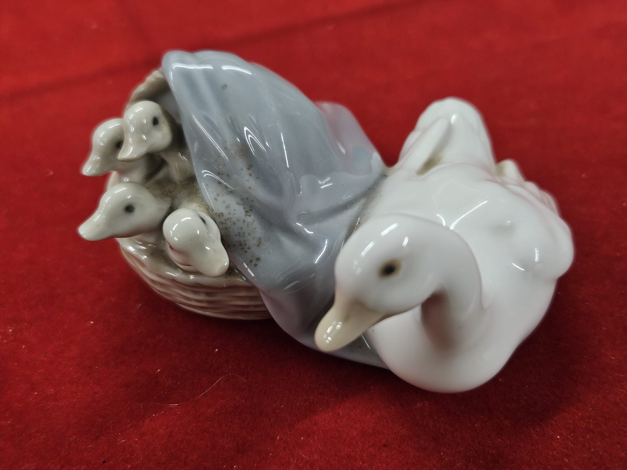A Lladró Mother Duck with Ducklings in a Basket Porcelain Figurine