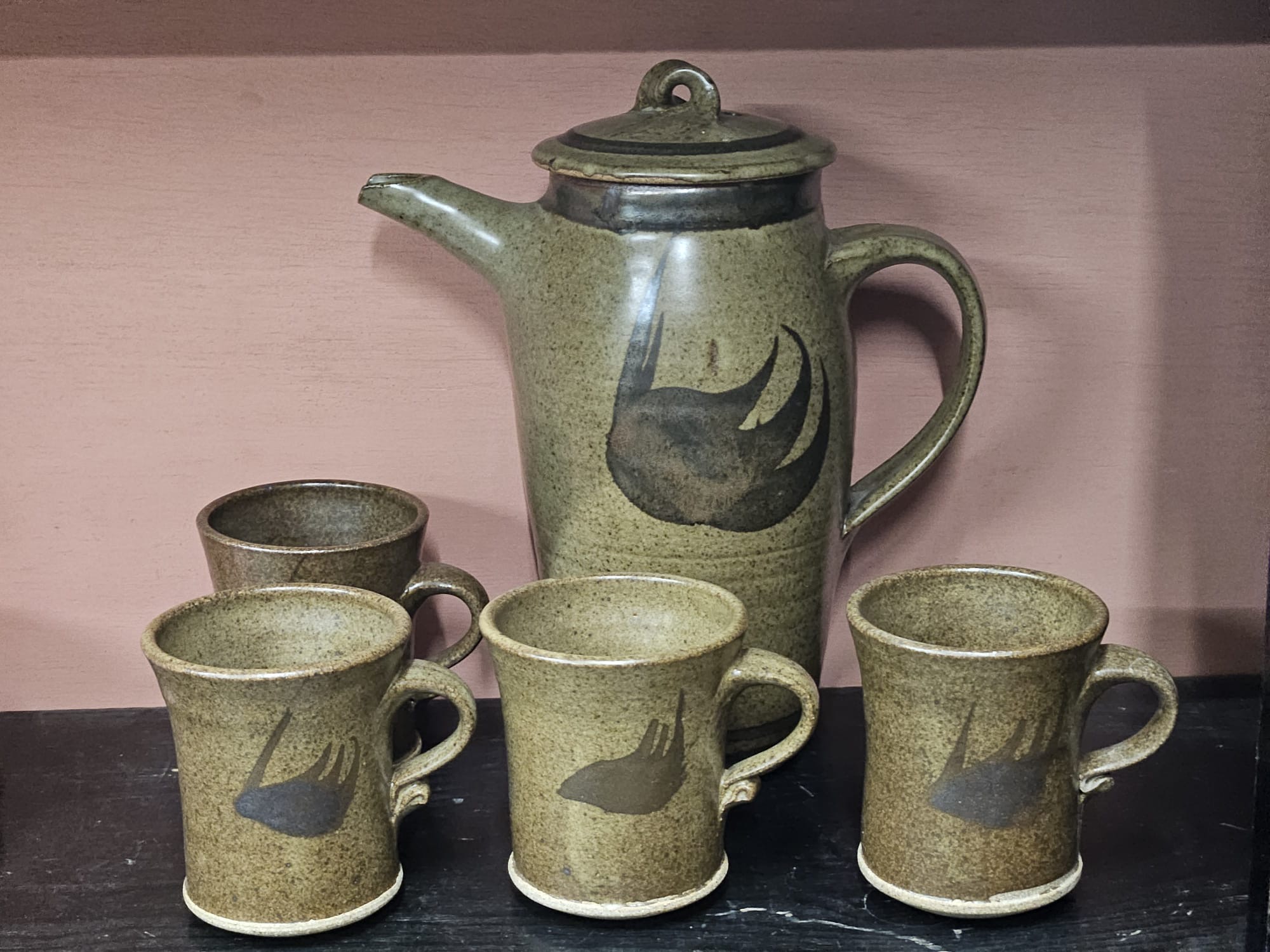 A studio pottery stoneware coffee pot and four matching mugs