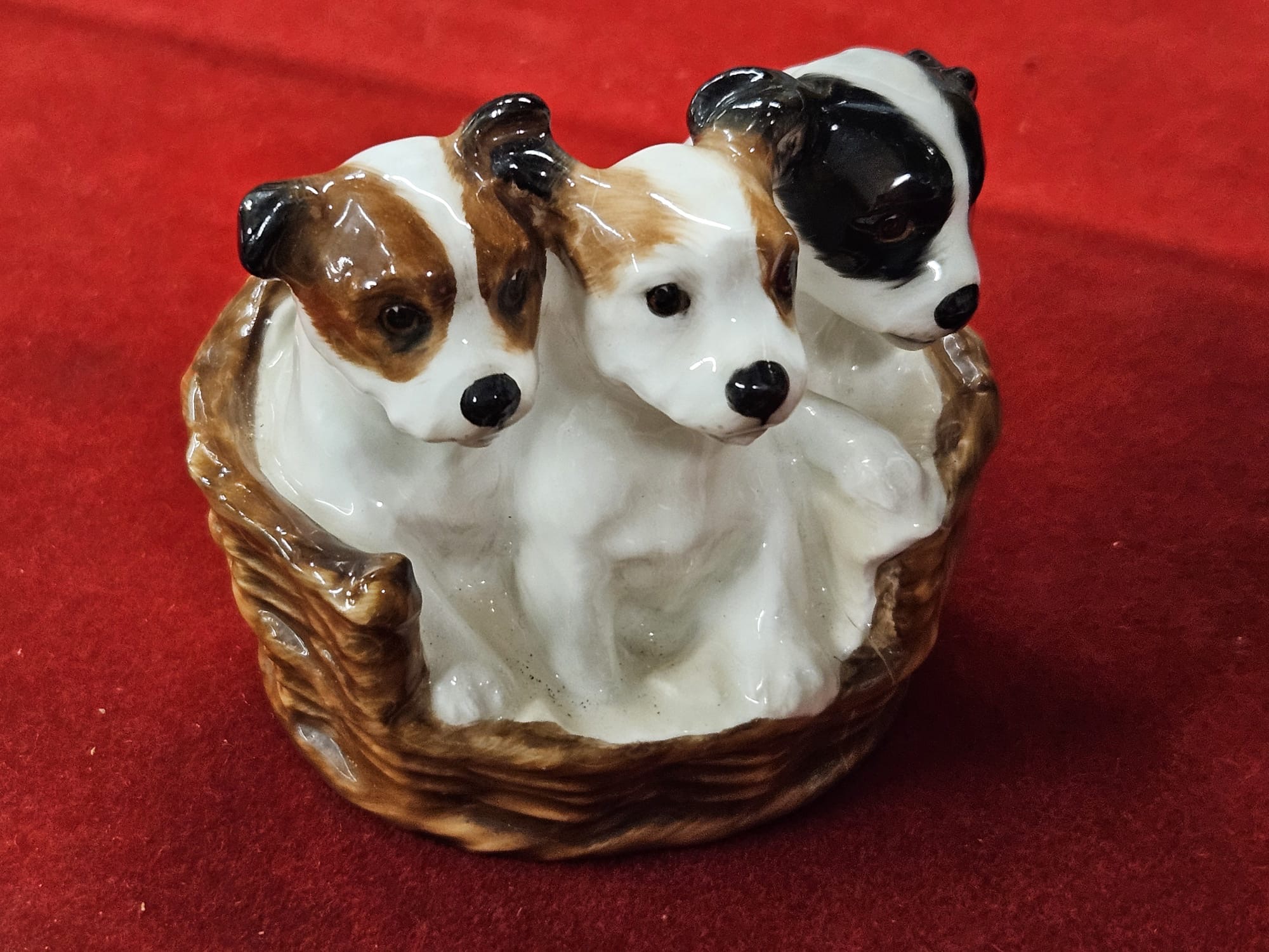 A Royal Doulton Bone China Figurine of Puppies in a Basket, HN 2588