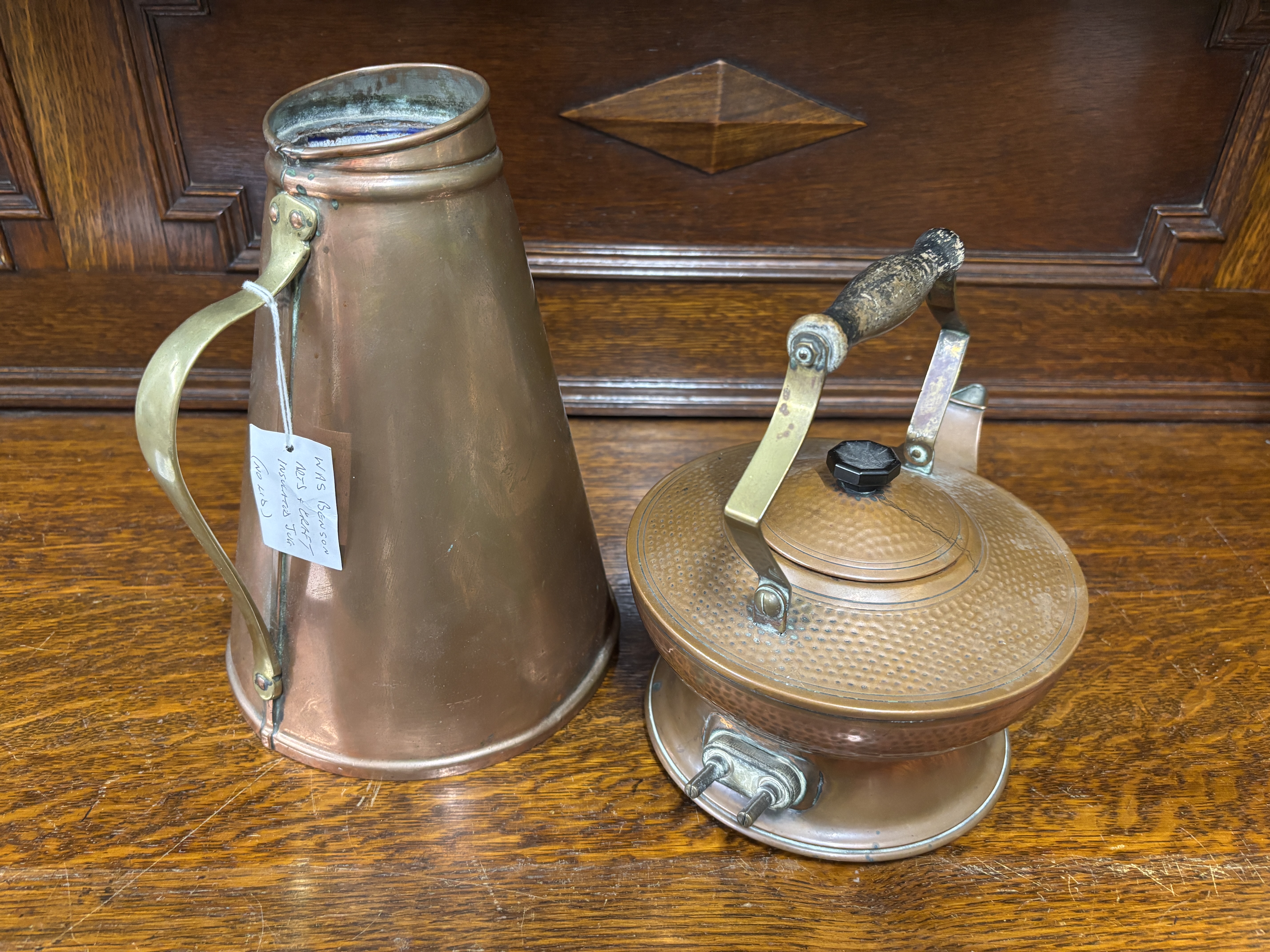 Two antique copper vessels comprising a hammered kettle and a tapered pitcher