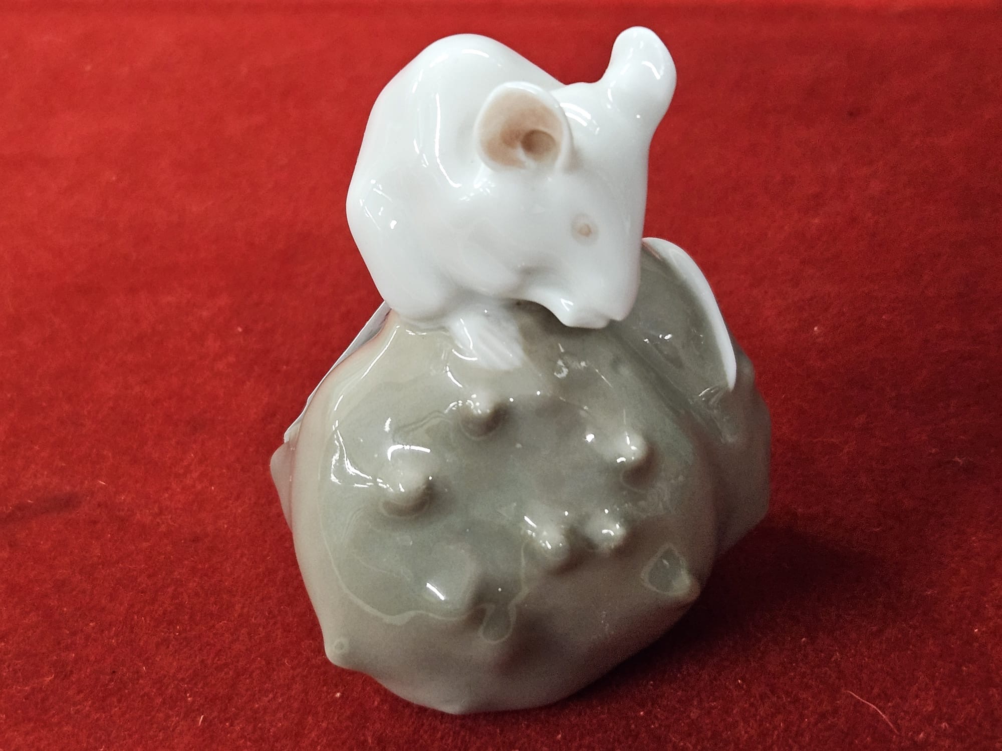 A Danish porcelain figurine of a mouse on a chestnut model number 511