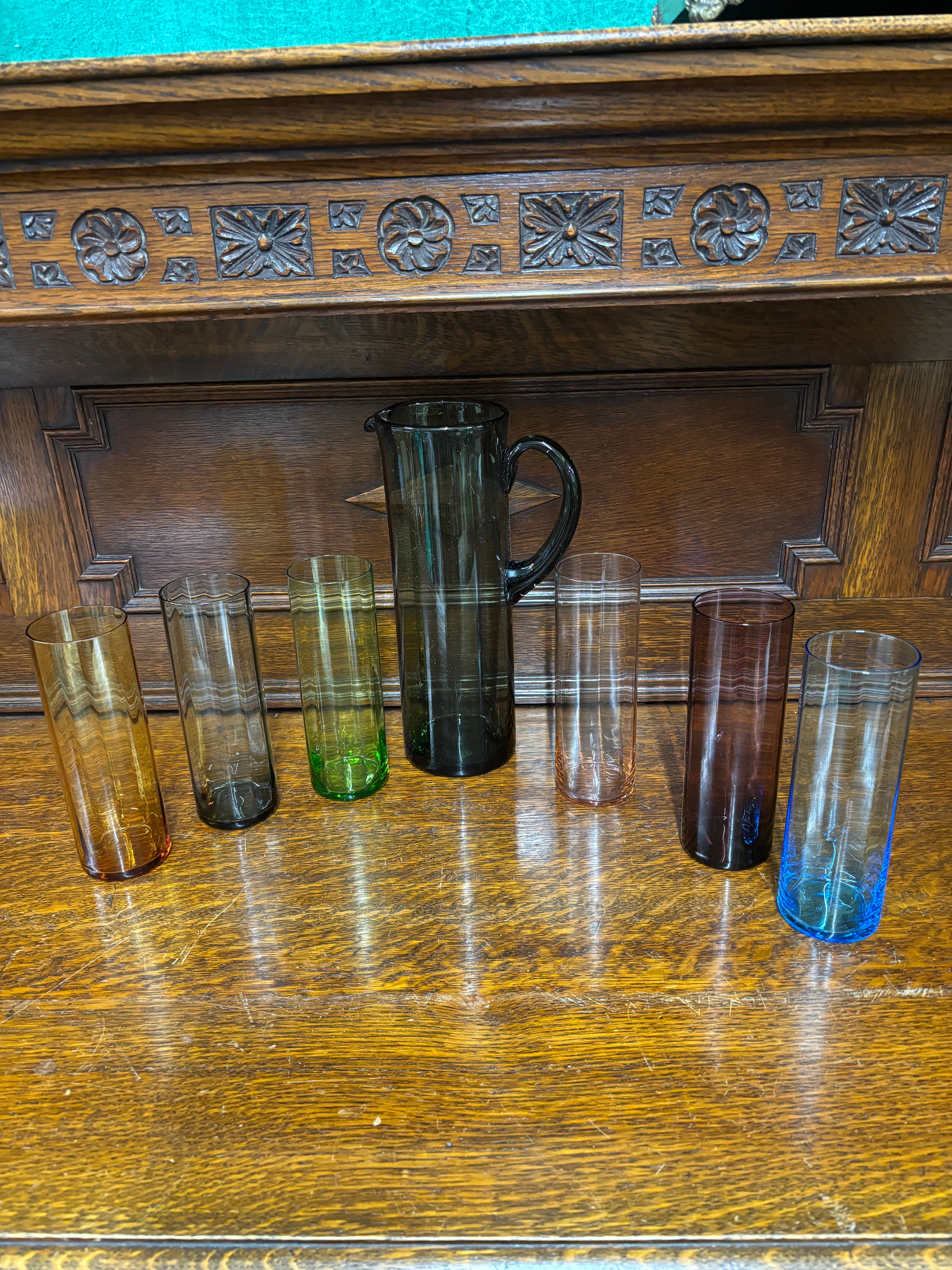 A set of six mid-century modern style multi-coloured glass tumblers and a coordinating pitcher
