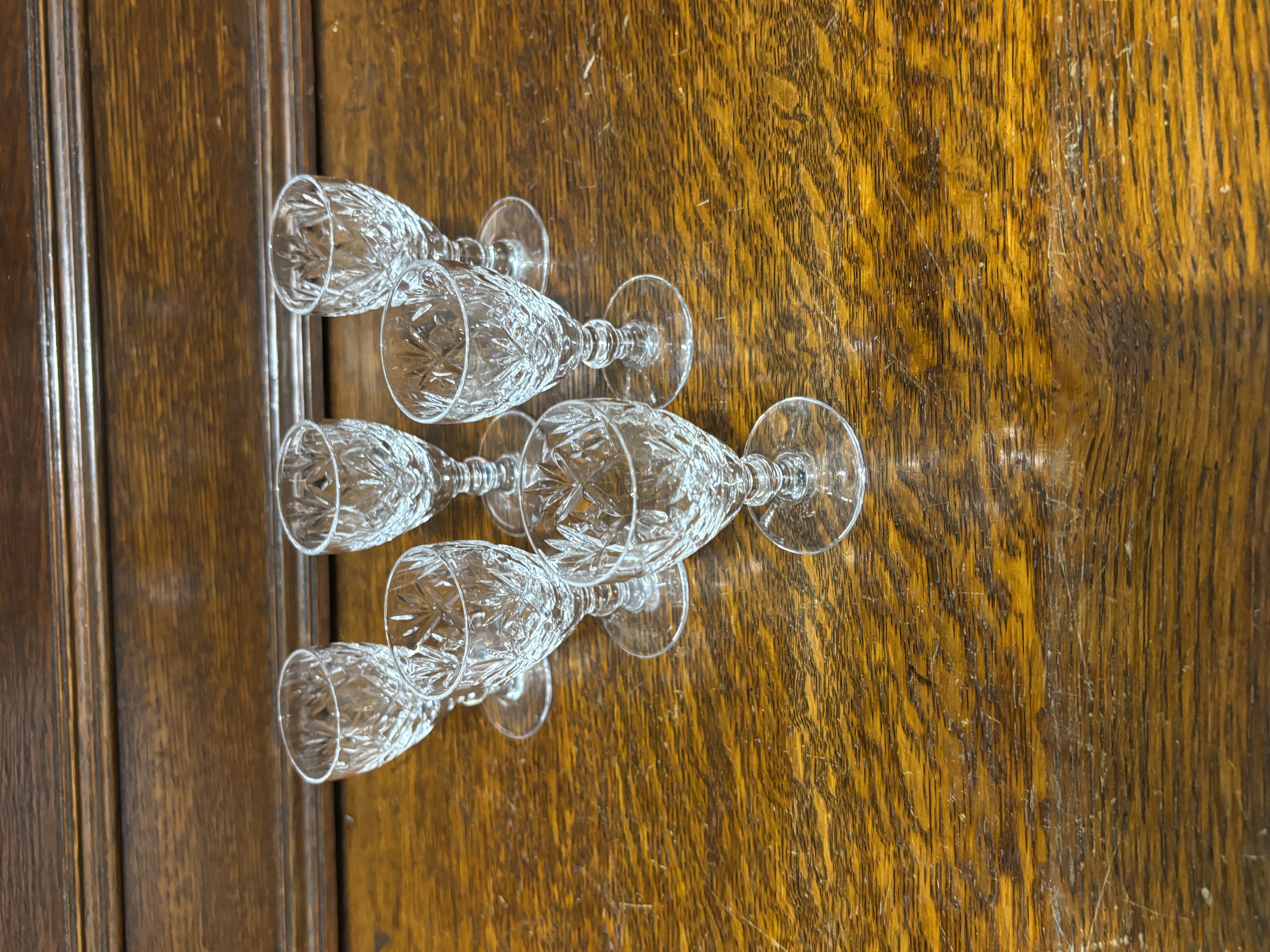 A set of six cut crystal liqueur glasses in the Lismore style