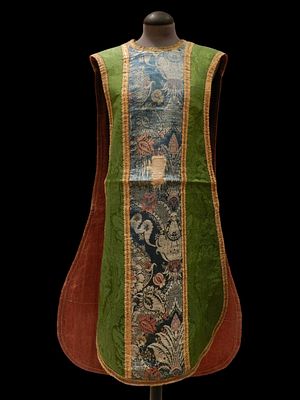Chasuble. 18th century. A green damask chasuble with a central band embroidered in blue and 