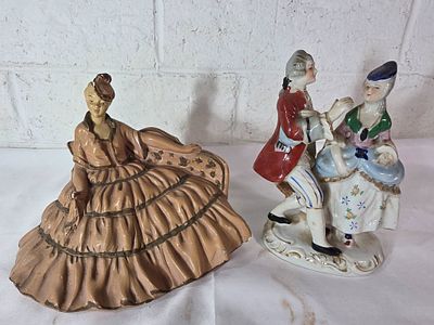 Ceramic Figurines Featuring Historical Attire. Ceramic figurines depicting individuals in