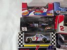 9 NASCAR 1:64 Scale Diecast Cars. Nine NASCAR 1:64 scale diecast cars featuring various iconic Image - 1
