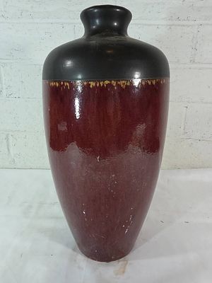 Red and Black Glazed Ceramic Vase. Ceramic vase with a tall, tapered form and a rounded narrow