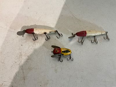 Vintage Fishing LuresÂ. Three vintage-style fishing lures, featuring two wooden lures with red 