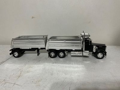 Â Dump Truck with Trailer. Die-cast model dump truck featuring a six-wheel truck cab and 