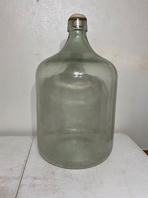 Glass Demijohn with CorkÂ. Clear glass demijohn featuring a rounded body with a narrow neck and 