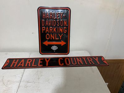 Harley-Davidson Metal Signs. Two Harley-Davidson-branded metal signs featuring black and red 