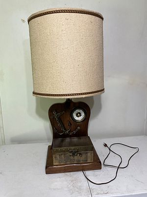 Nautical-Themed Table Lamp With Storage Box. Table lamp featuring a wooden base and backboard 
