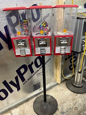 Red Triple-Head Candy Vending Machine. Triple-head vending machine with red metal frames and 