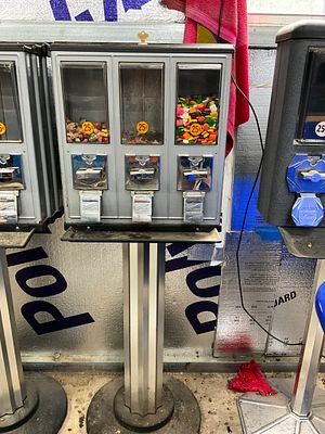 Triple Coin-Operated Candy Vending Machine. Triple coin-operated vending machine featuring three 