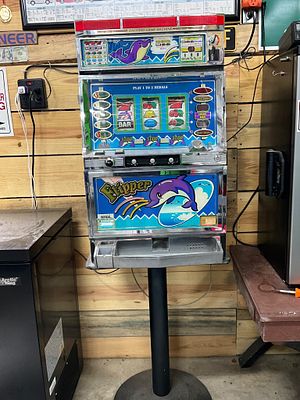 Vintage Flipper Dolphin-Themed Slot Machine. Dolphin-themed slot machine labeled "Flipper." 