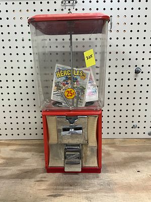 Red Countertop 25-Cent Coin-Operated Vending Machine. Coin-operated vending machine with a 