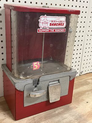 Red Metal 5-Cent Vending Machine. Red-painted metal and plastic vending machine designed for 