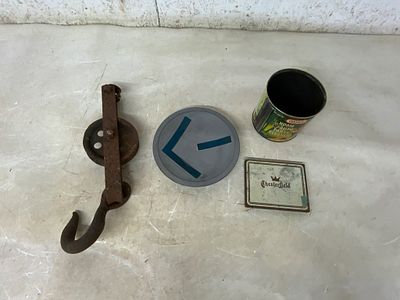 Miscellaneous Metal Objects. A rusted metal hook and pulley mechanism, a circular metal disc 